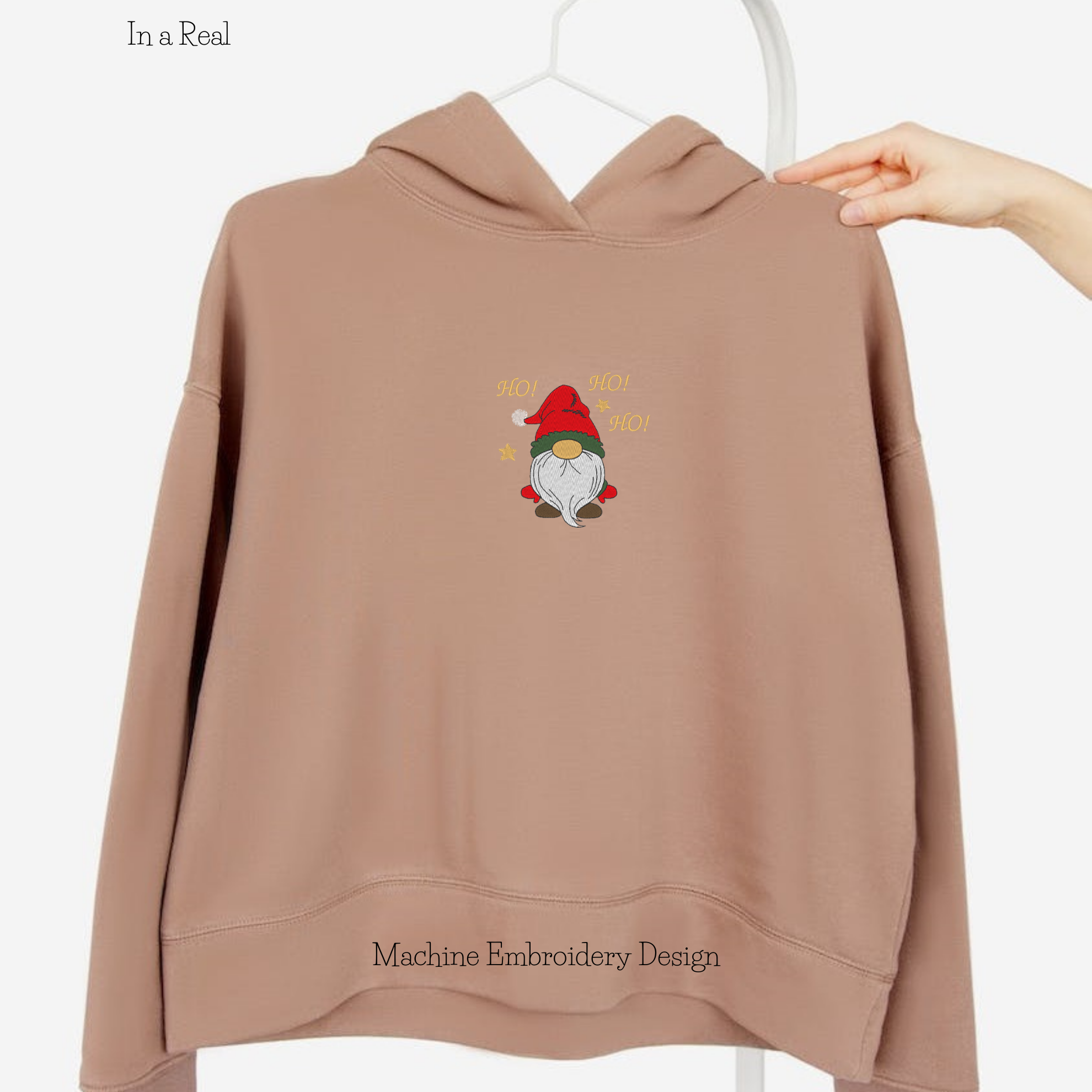 Machine embroidery design of Christmas gnome with the exclamation "Ho! Ho!Ho!" is  displayed on a hoodie