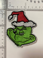 Close-up view of Grinch face character patch, ideal for adding a playful touch to holiday decorations.