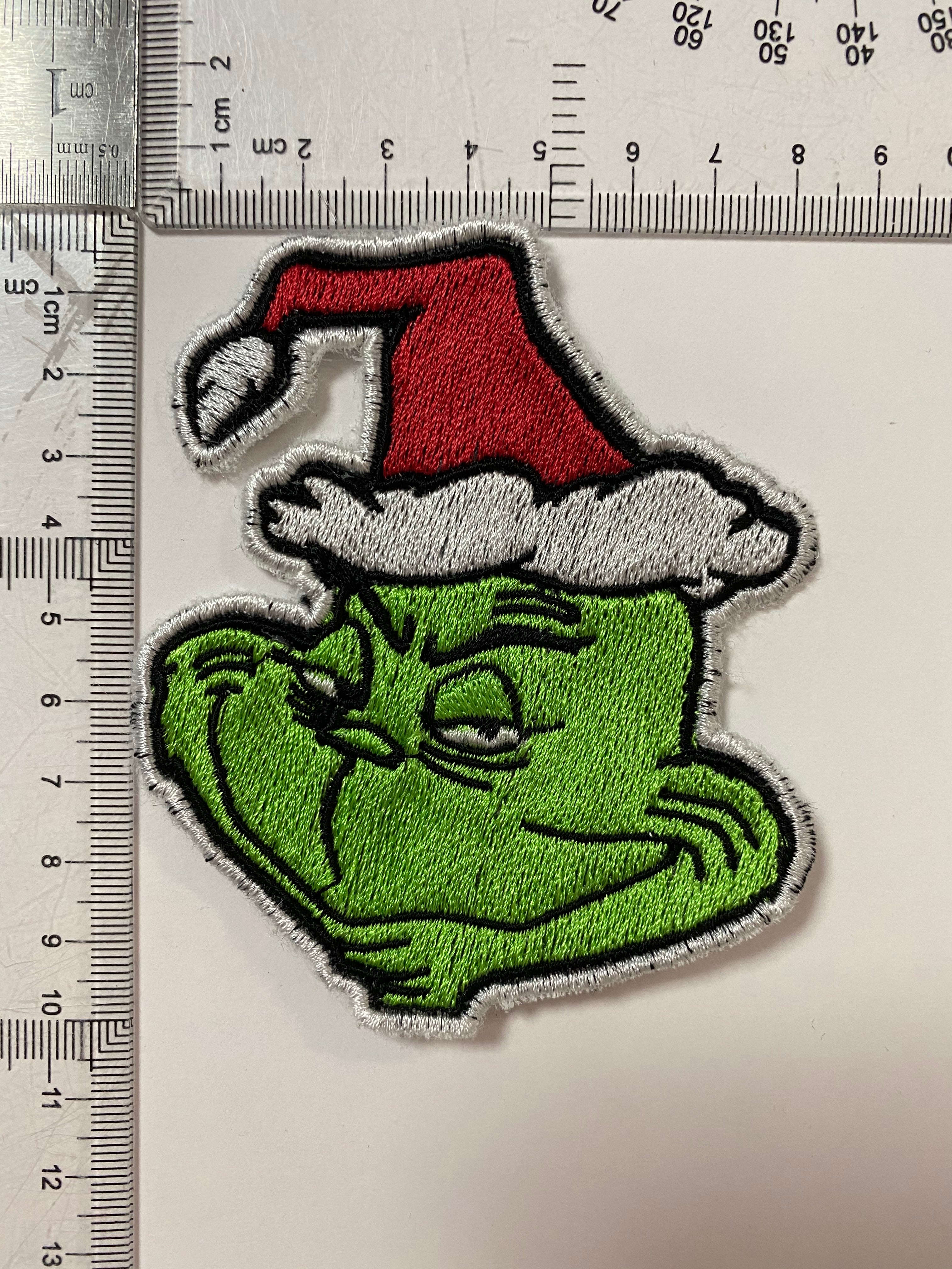 Close-up view of Grinch face character patch, ideal for adding a playful touch to holiday decorations.