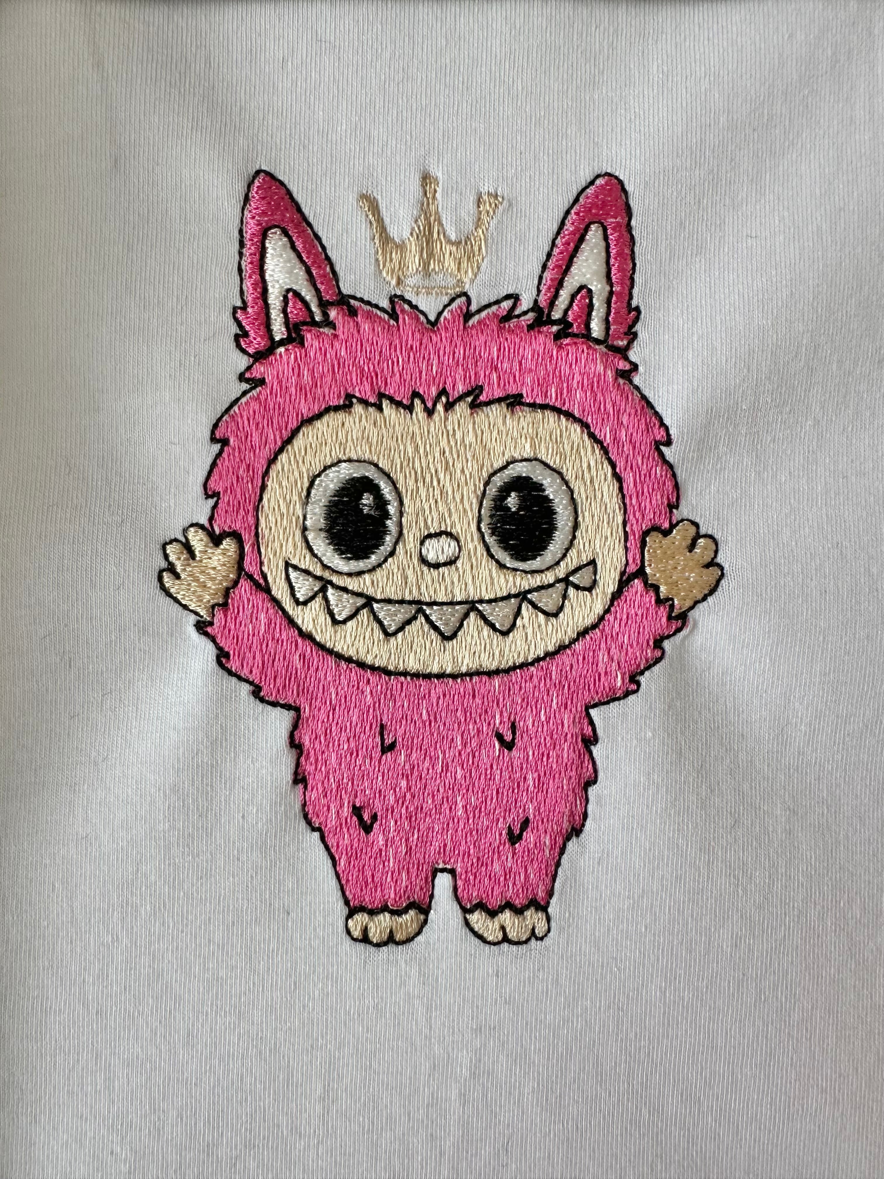 Labubu with crown Machine Embroidery Design in a real