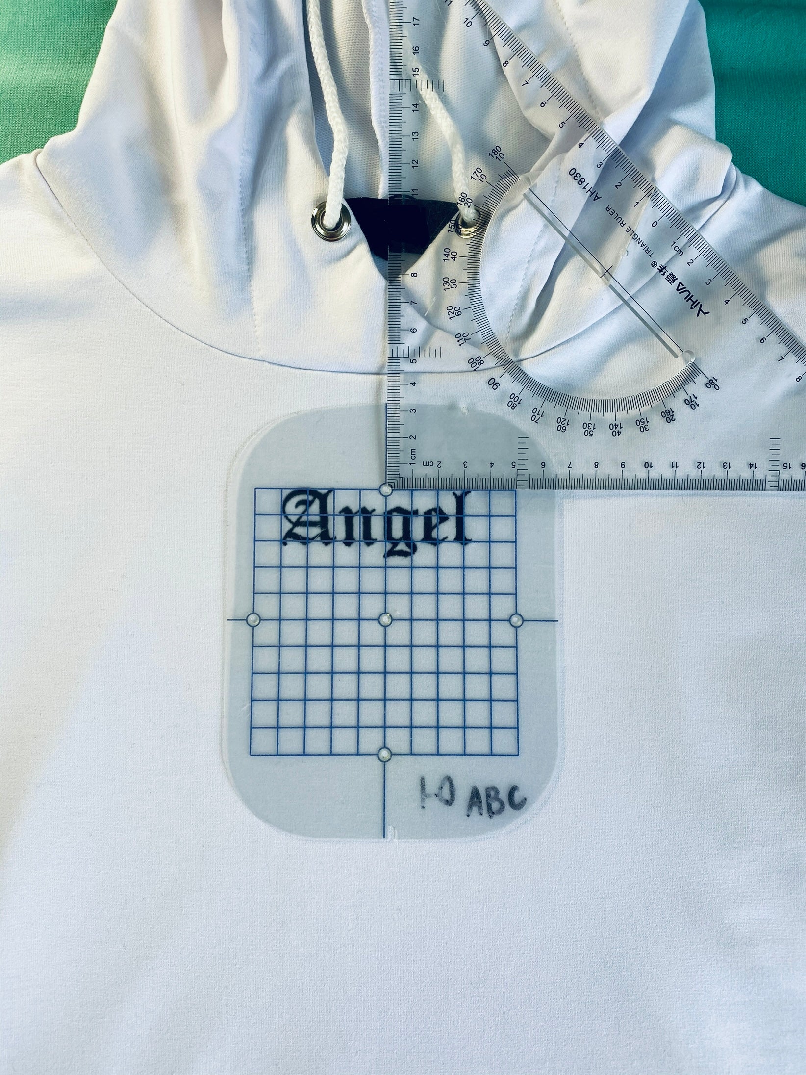 Angel written machine embroidery design displayed on a hoodie
